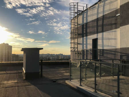 veranda on the roof of the house. metal structures for fencing off other people. own barbecue area on the roof. next to the house there is a staircase for access to the roof of a neighbor and evacuation.の写真素材