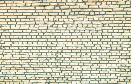 white brick wall. texture of small, bleached, concrete bricks. graphic decoration of the building...