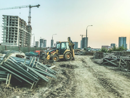 construction site of a new district. yellow construction equipment and building materials on site....