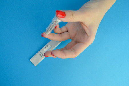 Express COVID-19 test for IgM and IgG antibodies to novel coronavirus SARS-CoV-2, Covid-19. Medics hand in glove loads blood to.の写真素材