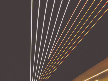 bright strips of LEDs on the ceiling. blue and white stripes, illumination. decoration of the ceiling in the subway. bright ribbons in the style of geometry fly to the plane.の写真素材