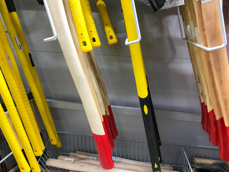 wood handles of various tools. wooden handles interspersed with metal of different colors. hardware...