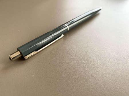 Automatic green ballpoint pen for writing on your desktop office desk. Business work.の写真素材