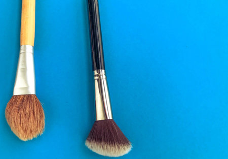 powder slide, a touch of foundation and two black makeup brushes.