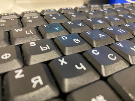 Close-up view of a black plastic keyboard with buttons on a work computer in a business office.