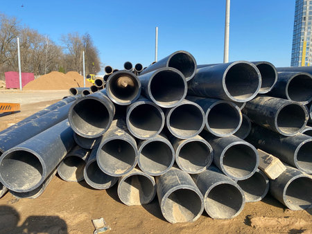 Gas polypropylene pipe in rolls on the street, black plastic pipes.