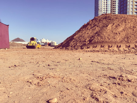 A large pile of yellow sand for the repair and construction of tall new buildings and structures of...
