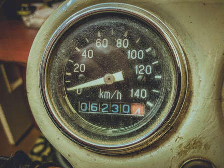 Closeup photo of a round black speedometer of an old Soviet motorcycle.の写真素材