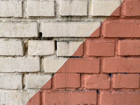 Red and white two-color diagonal bricks old surfaces shabby with seams painted with red and white...