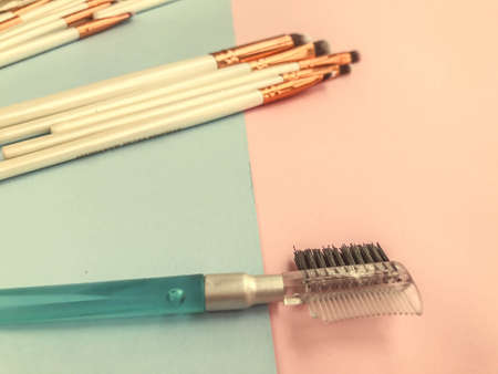 brushes lie on a bright background. eyebrow brush with disposable plastic brush. fine-bristled eye brushes for applying free-flowing matte textures to the eyes.の写真素材