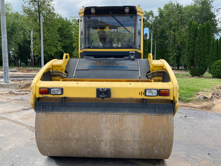 Yellow powerful large new modern road roller for asphalt paving and road repair at construction...