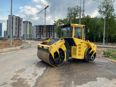 Yellow powerful large new modern road roller for asphalt paving and road repair at construction site. Construction machinery.の写真素材