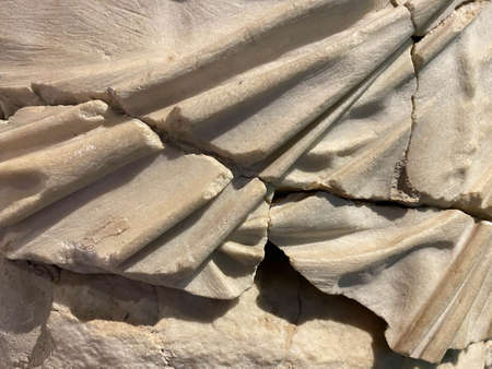 old chipped plaster on the concrete wall, cracks in old concrete wall, background texture.の写真素材