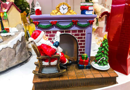 Red and white mini figure collection isolated on black. Christmas decoration, pine cones, fireplace on black background. Closeup.の写真素材