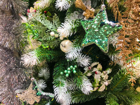Close-up view of beautiful decorated christmas tree with shiny baubles and garlands.の写真素材