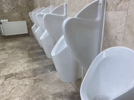 Row of white urinals in a public toilet.の写真素材