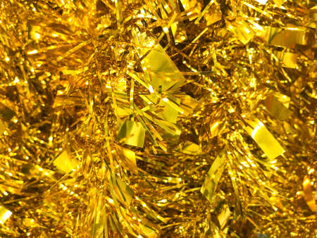 a lot of New Year's golden garland. Christmas. yellow shiny background.の写真素材