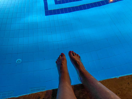Male Feet In Outdoor Swimming Pool.の写真素材