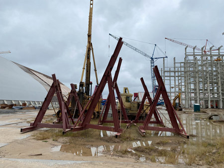 Construction site view of modern biomass co generation plant with people, cranes and construction...