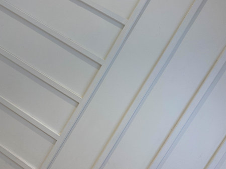White profiled metal sheet like wooden wall from diagonal planks.