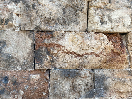 Old wall made of stone bricks forming a charming background.