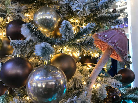Christmas tree decorated with Golden and blue balls toys on a blurred, sparkling and fabulous fairy background with beautiful bokeh, copy spacet.の写真素材