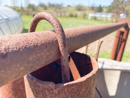 Rusty iron metal industrial pipe of large diameter old with holes for pumping liquid and...