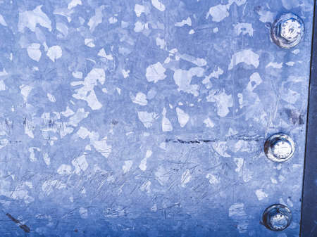 purple metal texture. paint on natural material. there are white blotches on the metal and a large bolt is screwed on. the background.の写真素材