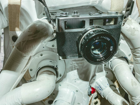 white suit with spacesuit astronaut in space. He has a small vintage camera hanging around his neck....