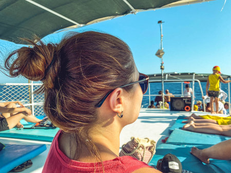 yacht in the open sea. sea with a sandy beach against the backdrop of a mountain. on board the yacht...