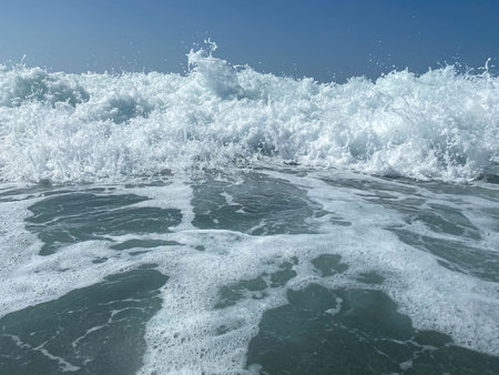 Beautiful sea with waves splashing warm sparkling clear blue water in a warm tropical oriental...