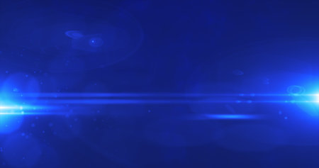Abstract blue background from rays of light in the dark and optical flares.の写真素材
