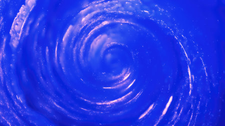 A luminous blue swirl forming a bright cosmic vortex in deep space, filled with light trails and radiance, conveying a sense of infinite mystery.の写真素材
