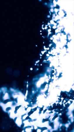 Blurred abstract composition of bright blue light splashes and glowing streaks forming a wave on dark background.の写真素材