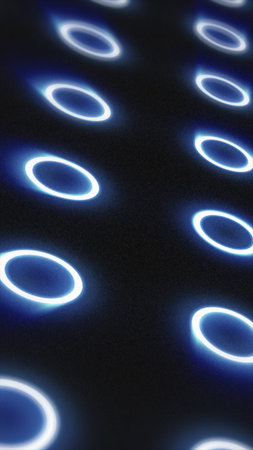 Futuristic glowing blue rings pattern on dark surface, minimal digital background.の写真素材
