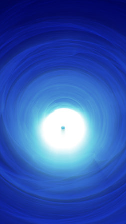 Abstract glowing blue vortex tunnel with bright center resembling futuristic energy flow.の写真素材