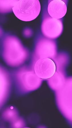 Soft glowing purple orbs floating in dark space, creating an abstract dreamy atmosphere.の写真素材