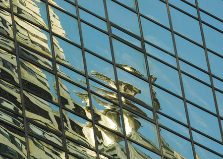 A reflection of an Art Deco gargoyle on the Chrysler Building, reflected in the glas of a skyscraper...