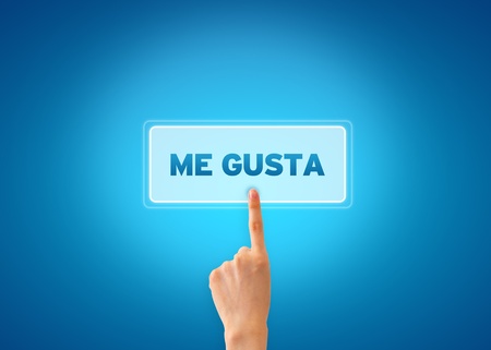 Hand pointing at a Me Gusta icon on blue grandient background. の写真素材