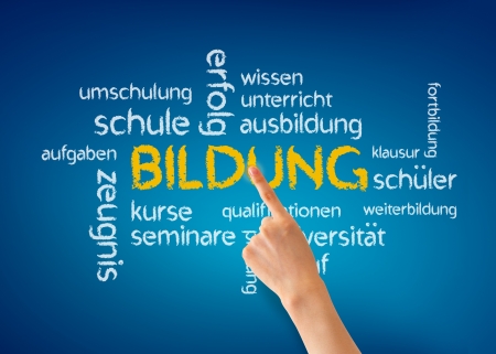 Hand pointing at a Bildung word illustration on blue background.の写真素材