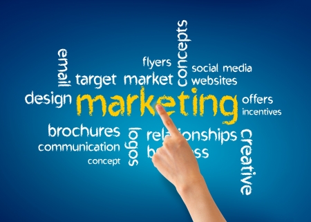 Hand pointing at a Marketing word illustration on blue background.の写真素材