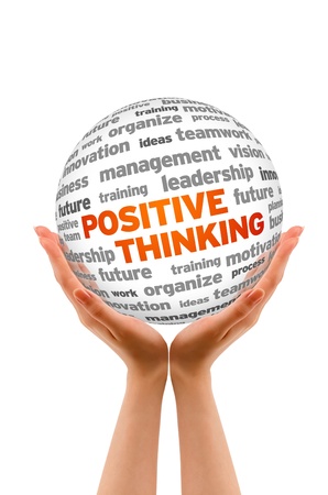 Hands holding a Positive Thinking Word Sphere sign on white background.の写真素材