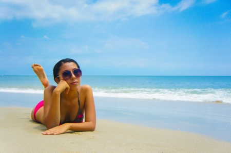 Young woman lying  on beach sun tanning.の写真素材