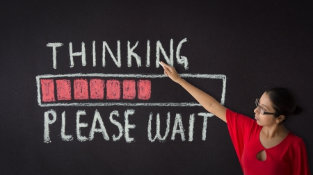 Woman pointing at a thinking please wait sign.の写真素材