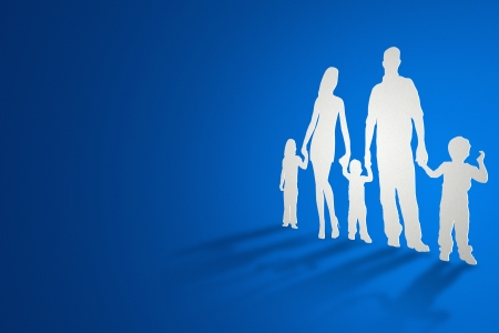 A family cutout from paper standing and casting shadows.の写真素材