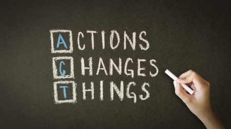 A person drawing and pointing at a Action Changes Things Chalk Drawingの写真素材