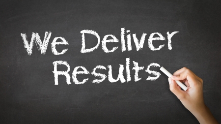 A person drawing and pointing at a We deliver Results Chalk Illustrationの写真素材