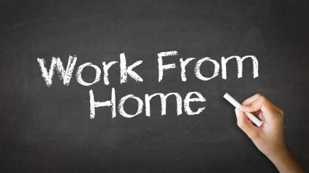 A person drawing and pointing at a Work From Home Chalk Illustrationの写真素材