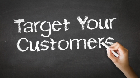 A person drawing and pointing at a Target Your Customers Chalk Illustrationの写真素材