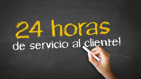 A person drawing and pointing at a 24 hour client Service Chalk Illustrationの写真素材